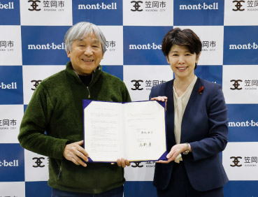 奈良県黒滝村とモンベルとの包括連携協定締結式の写真。左にモンベル代表・辰野 勇、右に笠岡市・栗尾 典子市長が立っています